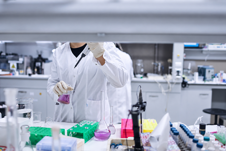 Laboratory professional pipetting a reagent sample